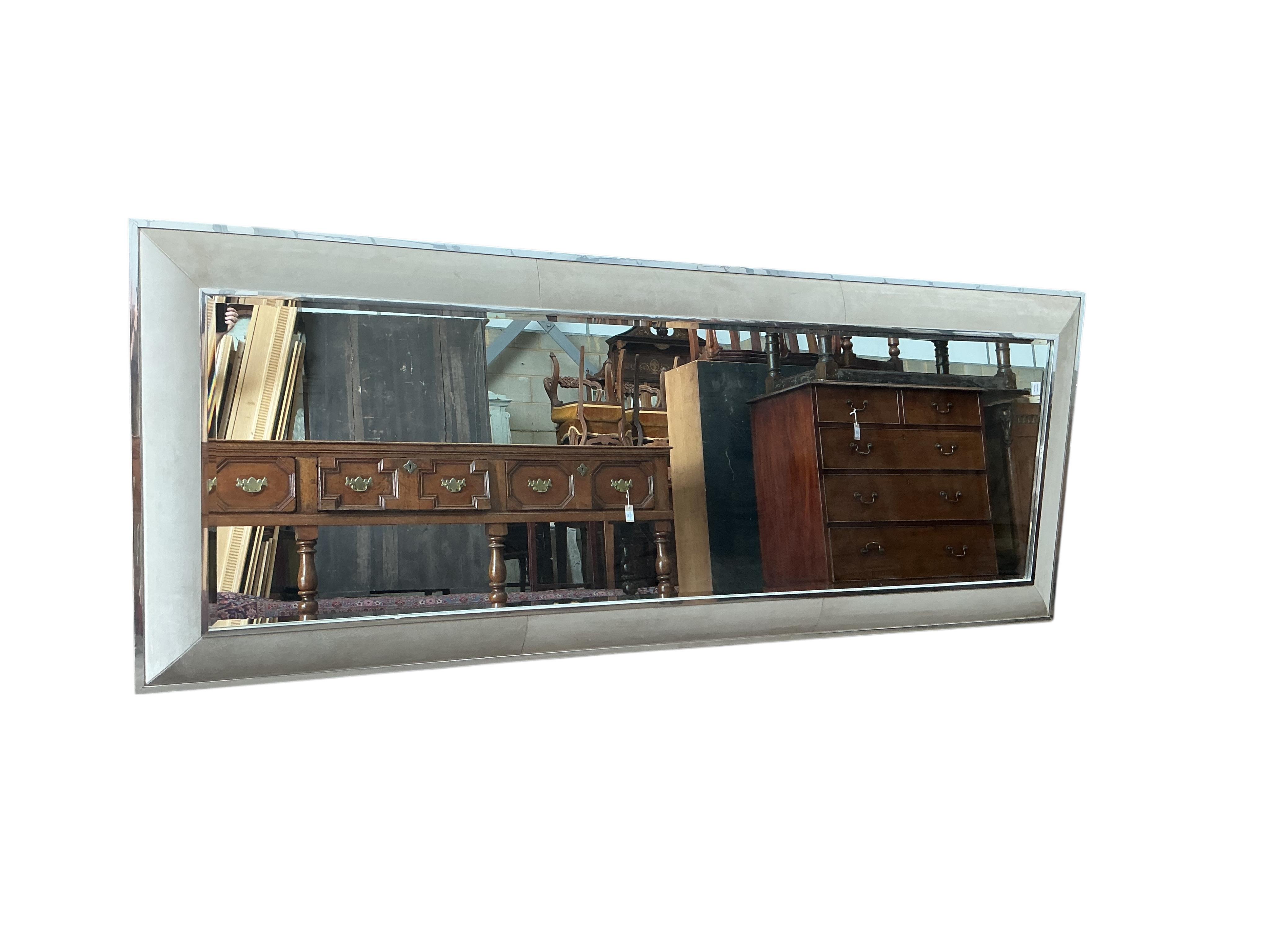 A large contemporary suede effect and chrome mirror, 280 x 100cm